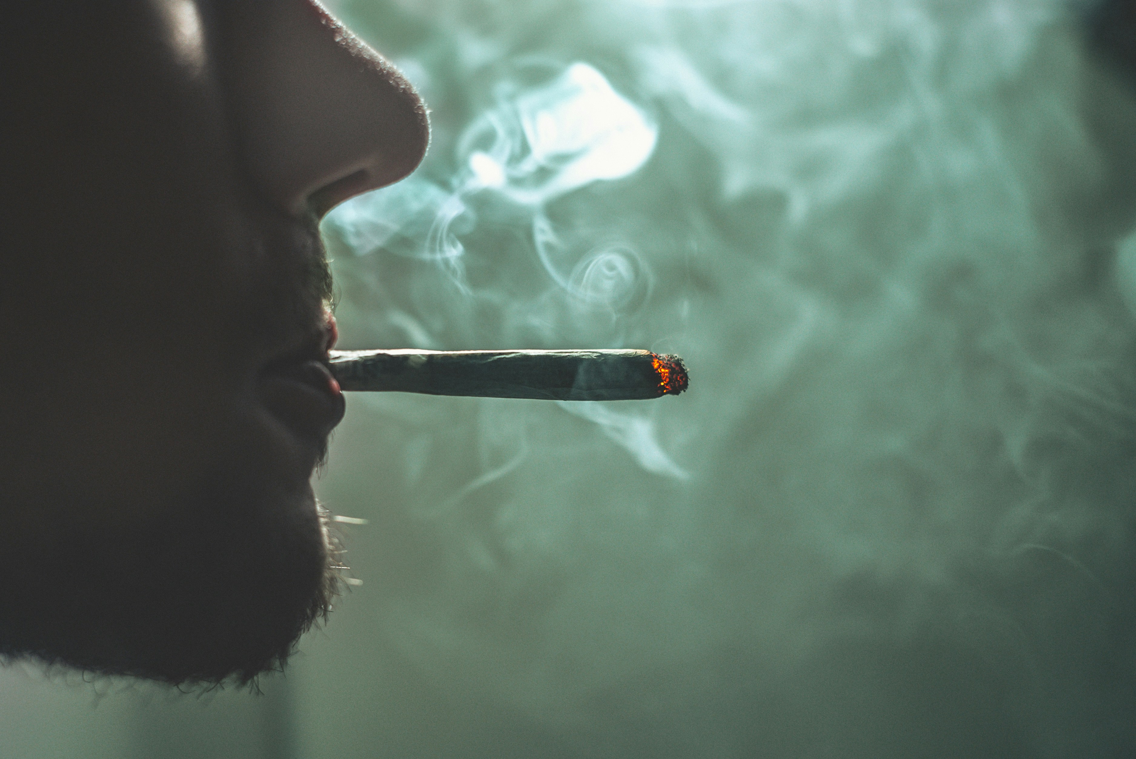 Man smokes a joint full of bubble hash