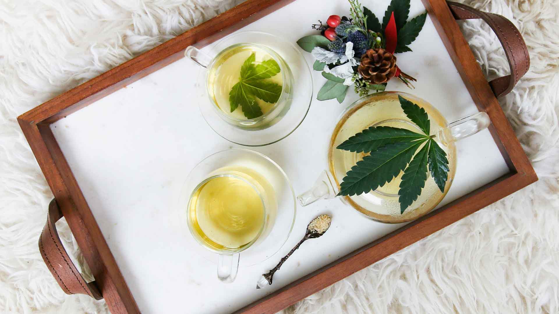 white serving tray with cannabis-infused honey and tea
