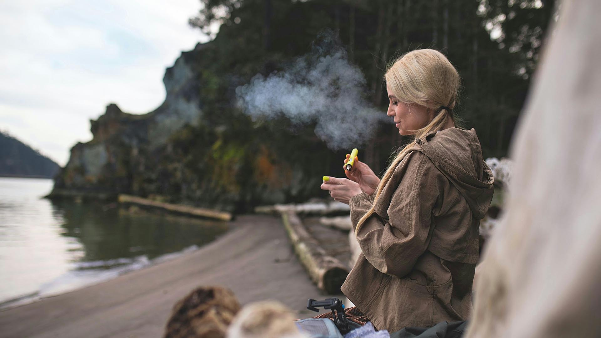 Woman on beach vaping crumble concentrate