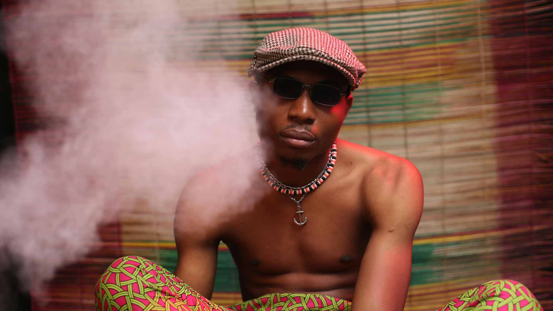 Man sitting in a cloud of cannabis smoke