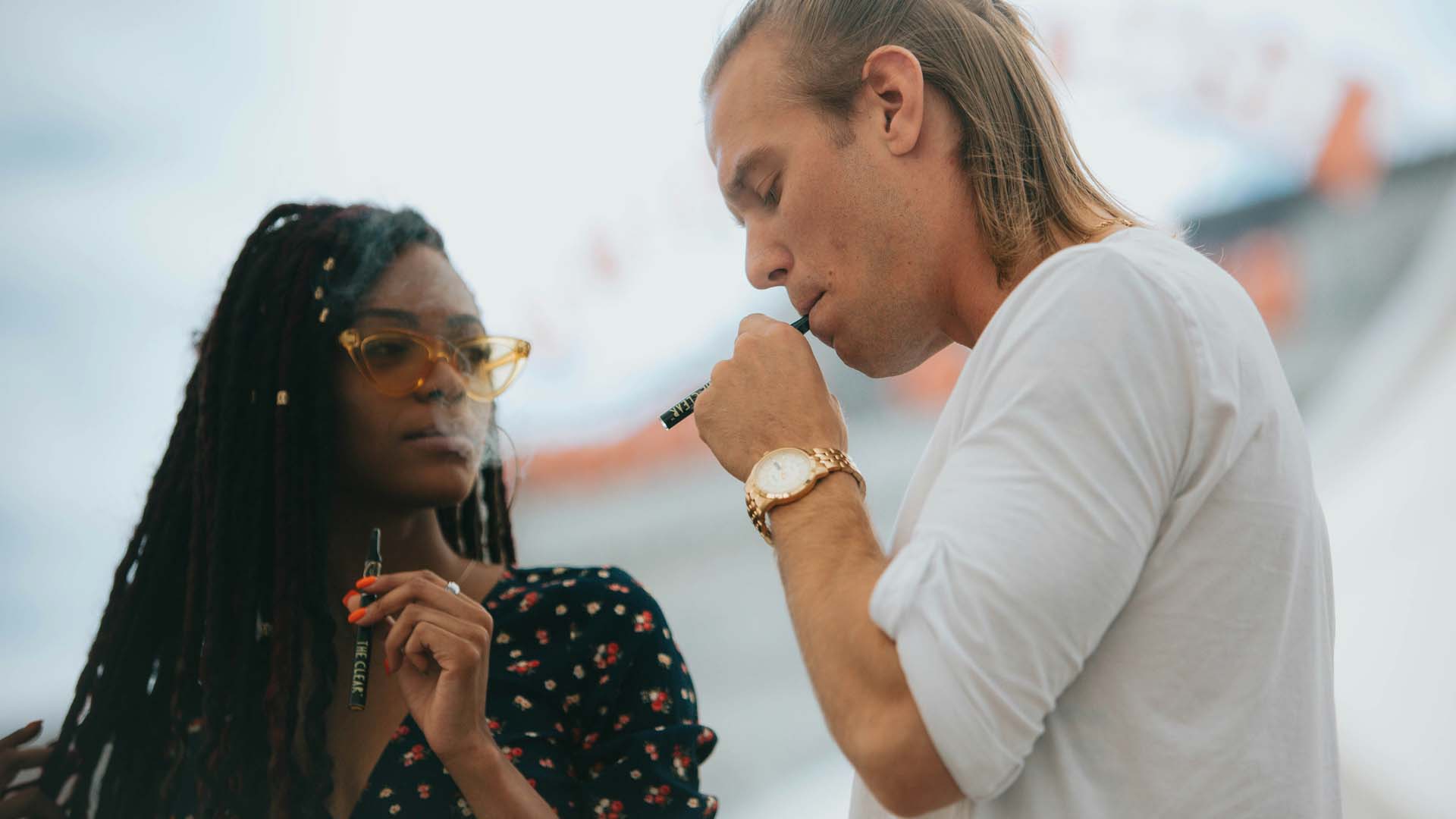 A man and woman vaping