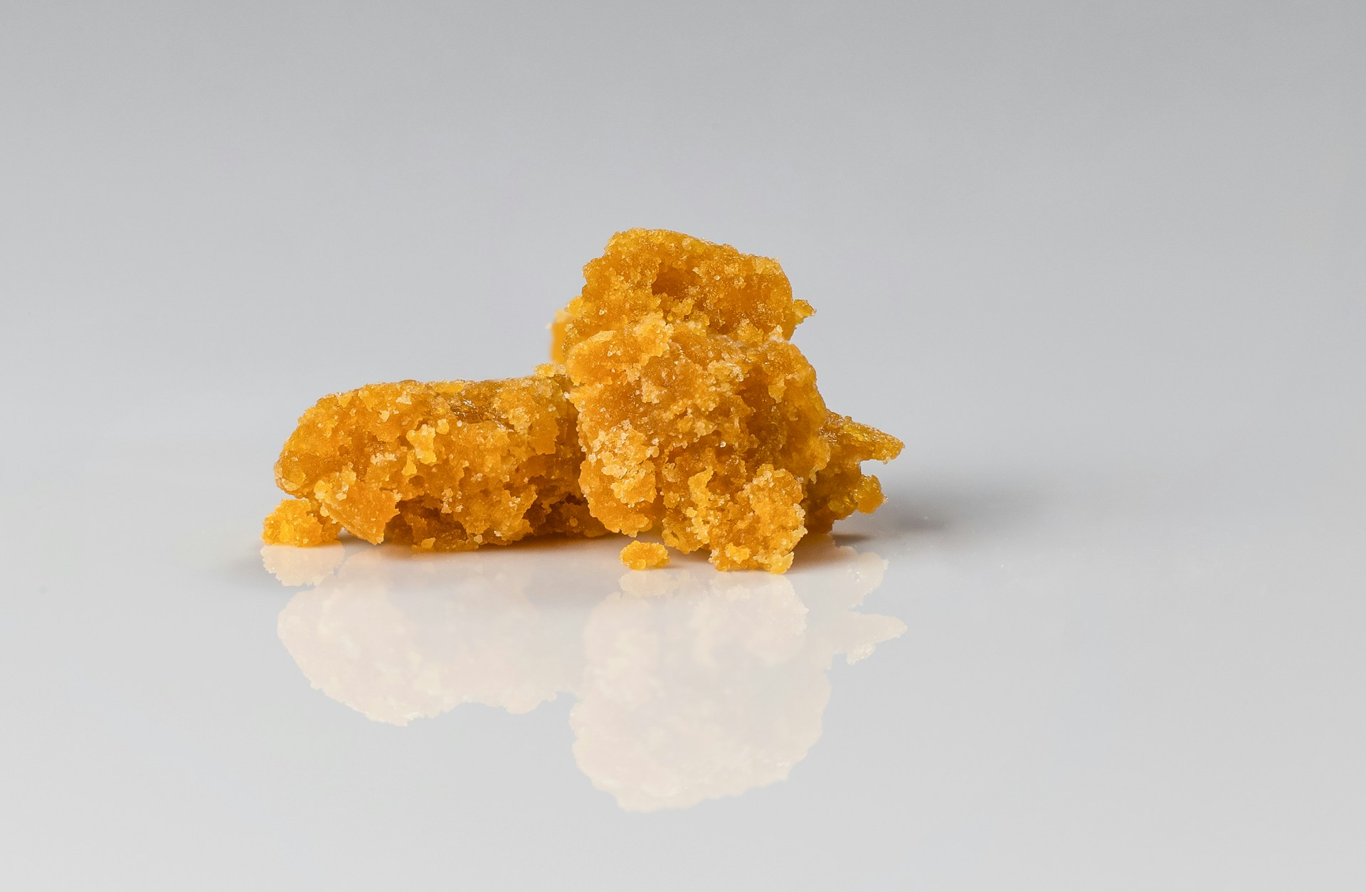 Crumbly cannabis wax against white background