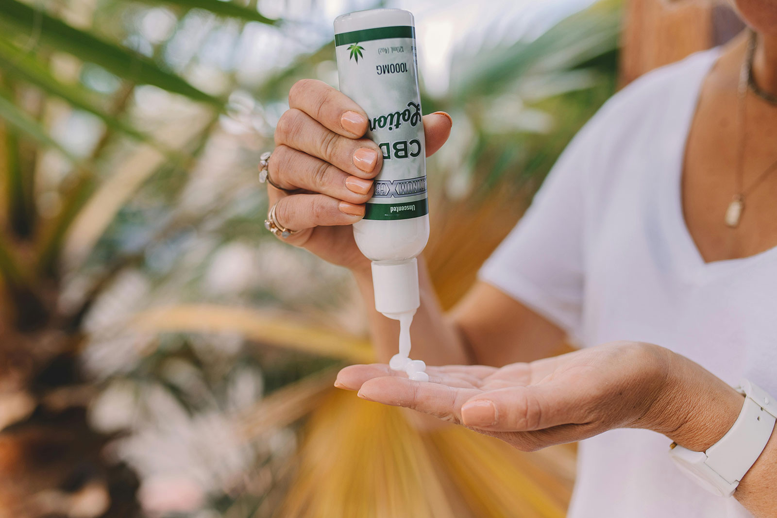 A person applying CBD lotion