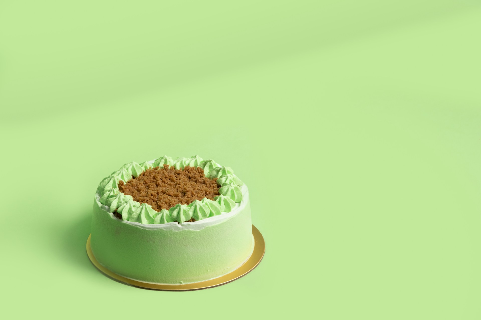 A green cake on a round plate