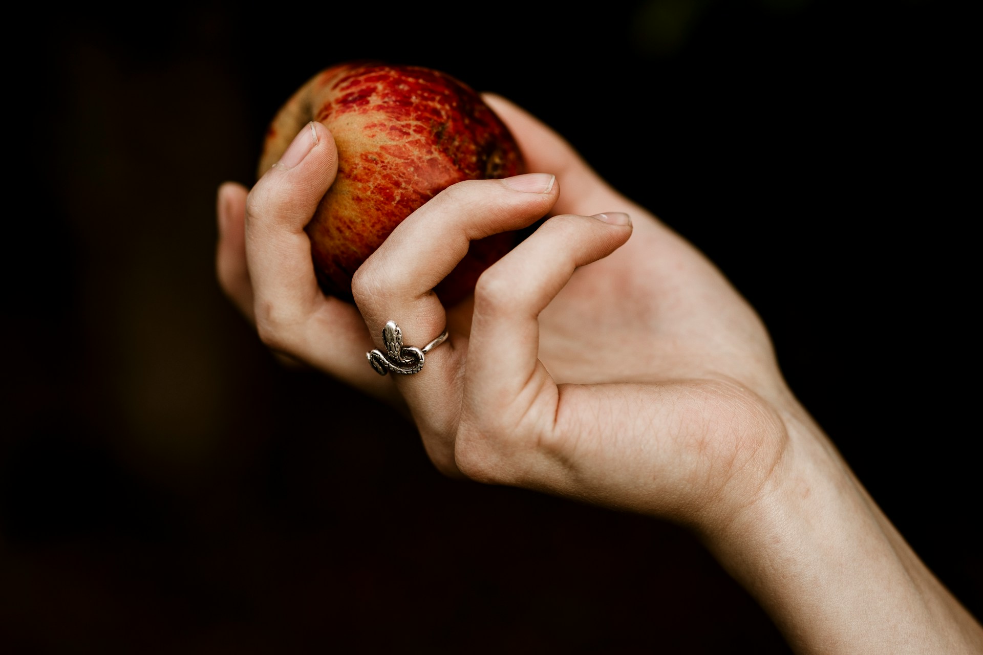 Female hand holding a potential red apple pipe